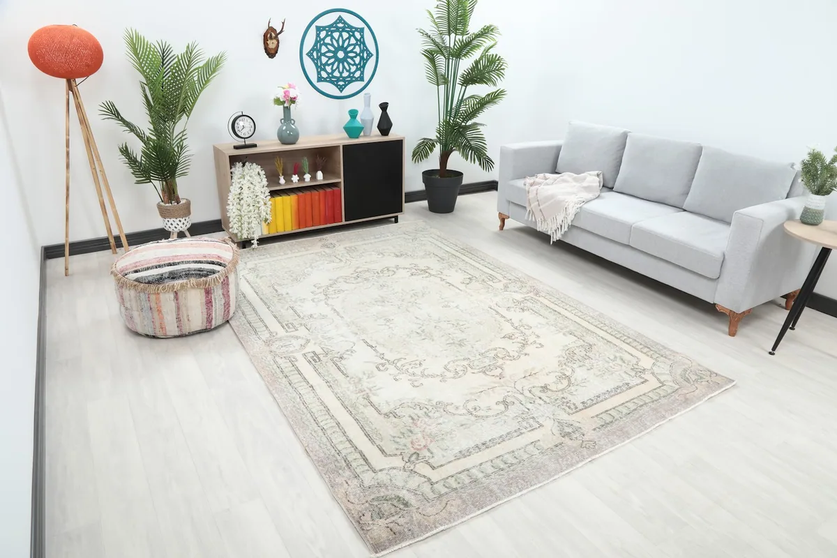 Angle view of the ivory and gray vintage rug in a living room, showing its placement relative to furniture.