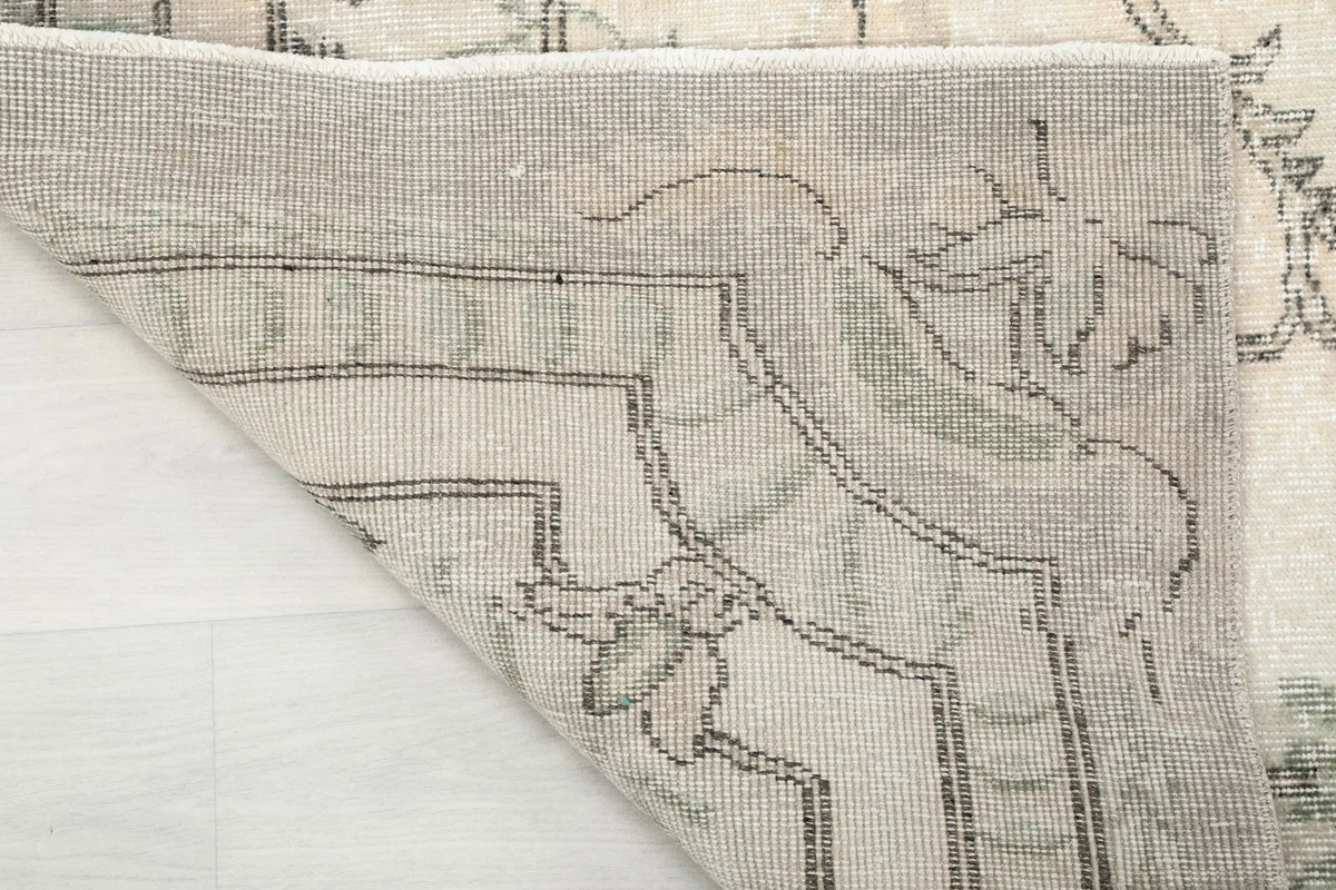 Close-up of the folded corner, showing the wool pile and the construction of the rug's back.