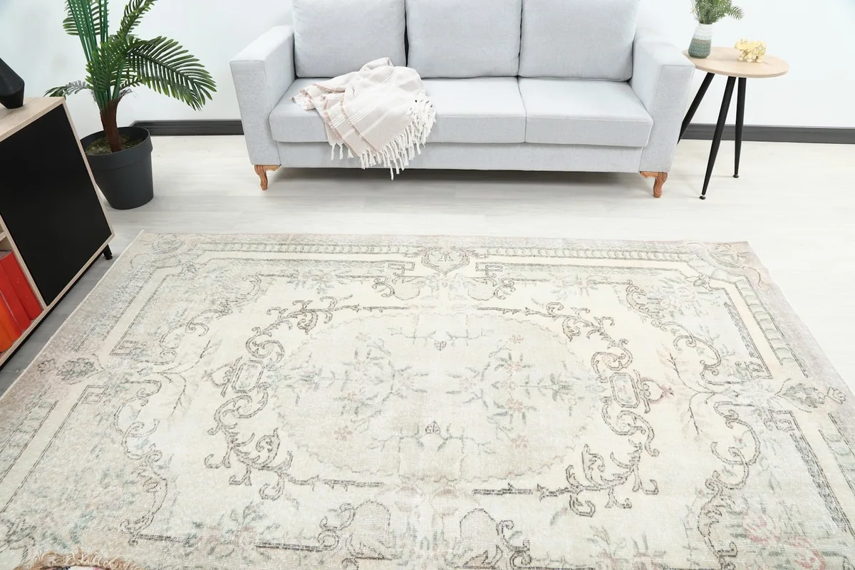 Overhead view of the ivory rug in a room, highlighting the central medallion and overall design.