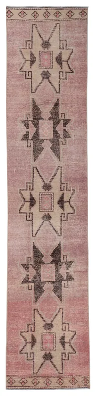 Full overhead view of the 2'9" x 13'3" vintage Anatolian runner rug with rose and beige geometric patterns.