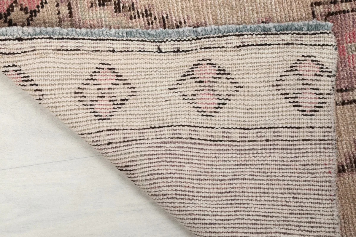 Close-up of the back of the rug, revealing the tight hand-knotting and cotton foundation.