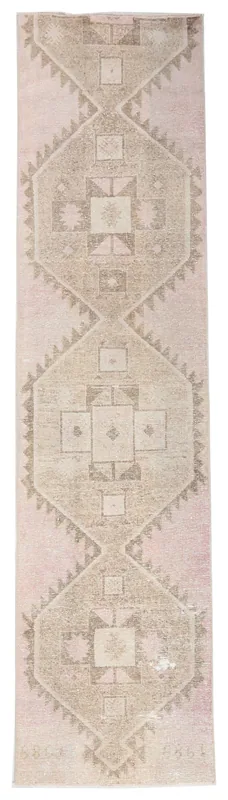 Full top view of the 2'8" x 10'8" rose and tan geometric vintage Anatolian runner rug