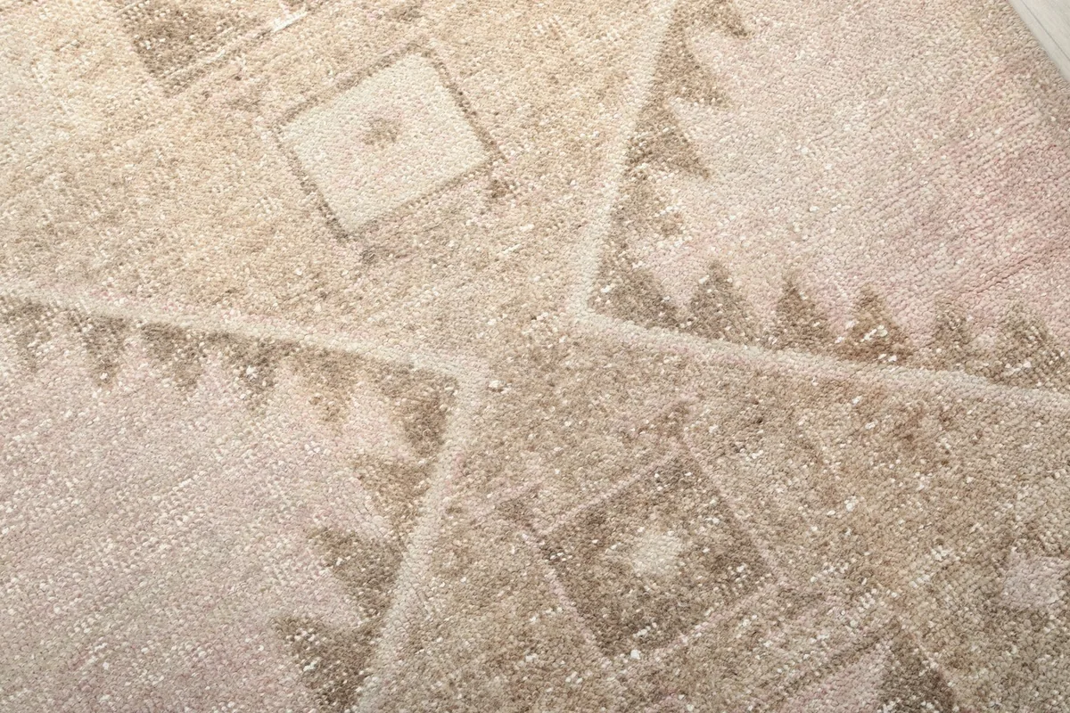 Intricate detail of the faded tribal geometric patterns and texture of the wool pile
