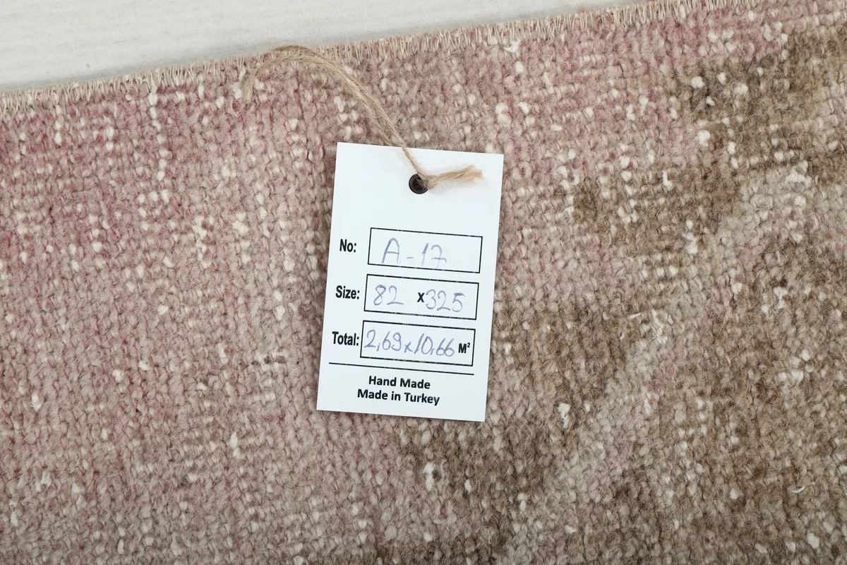 Product tag displaying the rug's dimensions and origin, resting on the wool pile