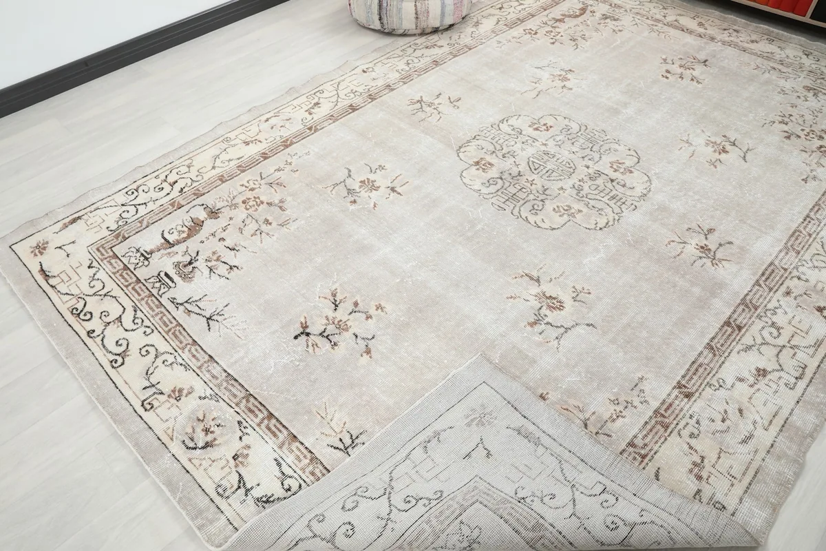Rug corner folded back to reveal the cotton foundation and reverse side of the hand-knotted construction