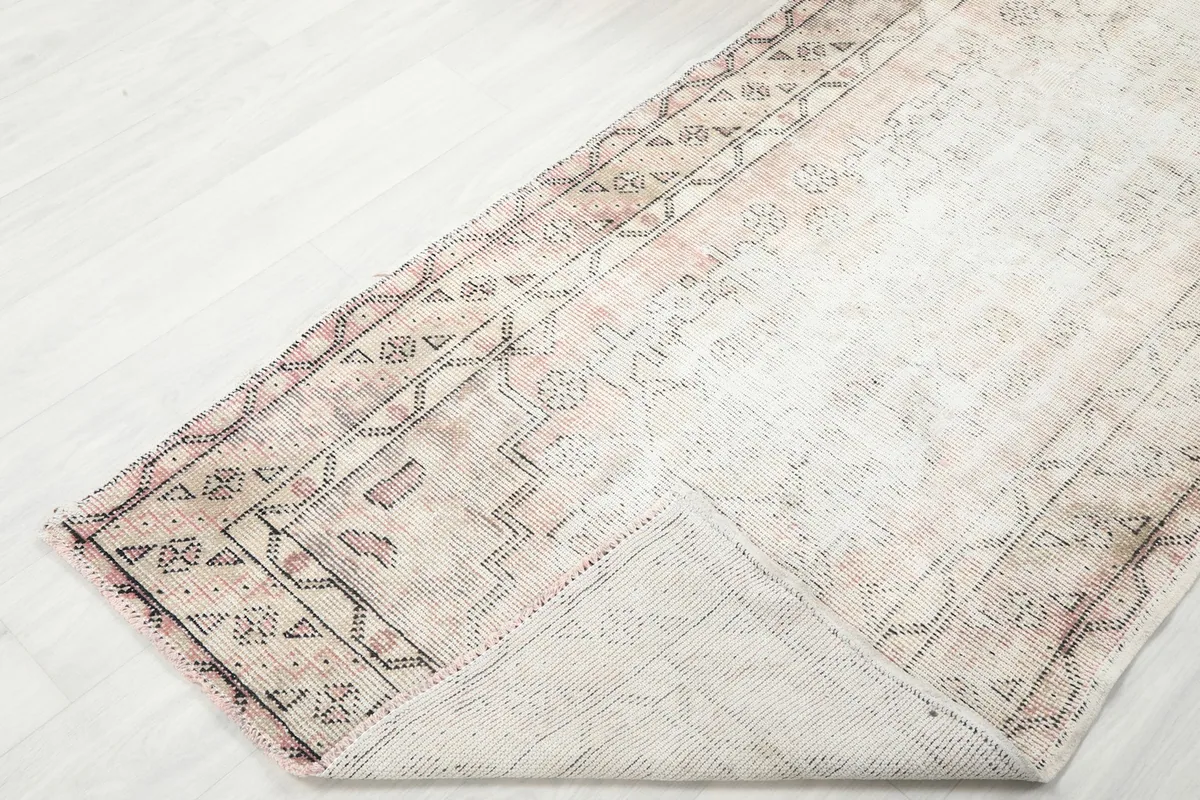 View of the runner rug slightly folded to show its thickness and back texture