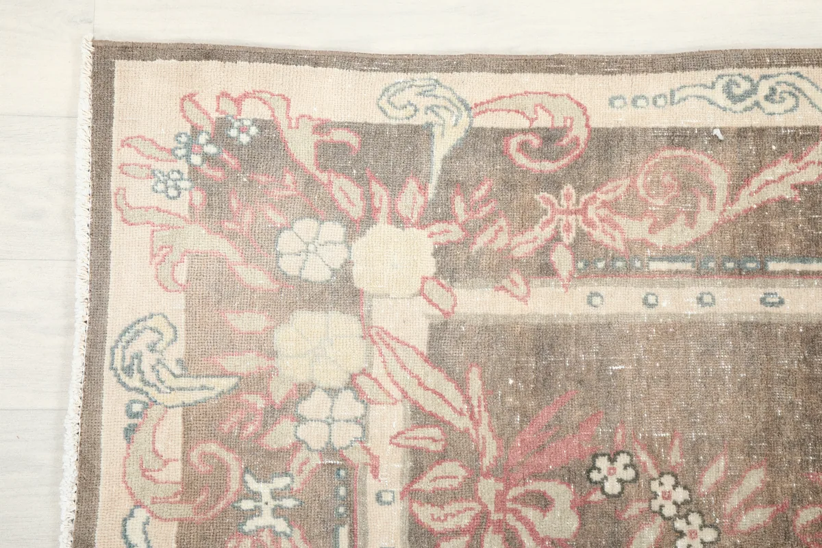 Close-up of the border and corner of the Gray Rose Medallion Anatolian Rug, revealing intricate patterns.