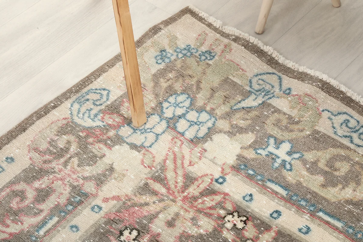 Another corner view of the Gray Rose Medallion Anatolian Rug, highlighting the faded border design.