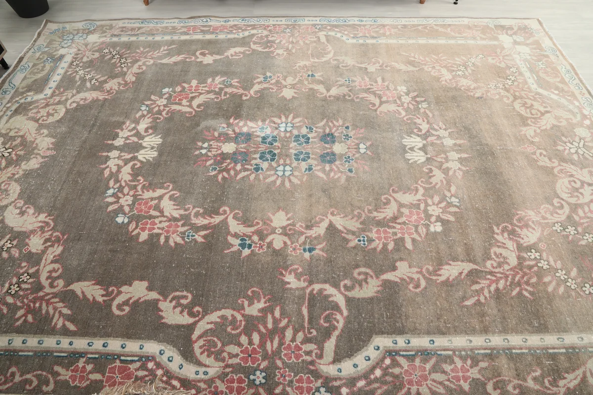 Overhead angled view of the Gray Rose Medallion Anatolian Rug, focusing on the overall pattern and color variation.