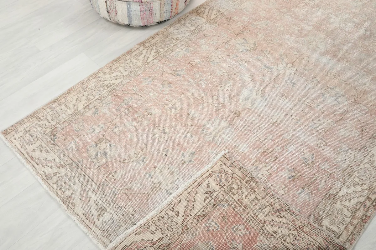 Rug partially folded, illustrating its flexibility and the consistent pattern