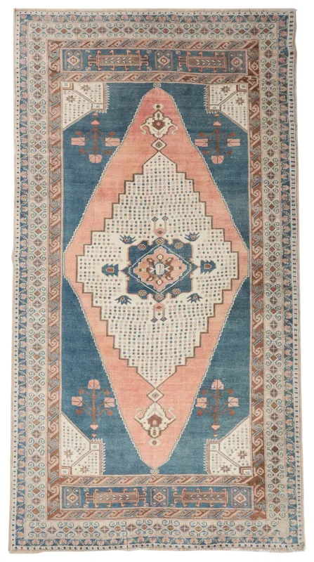 Full top view of the blue and rose vintage Anatolian area rug on a white background