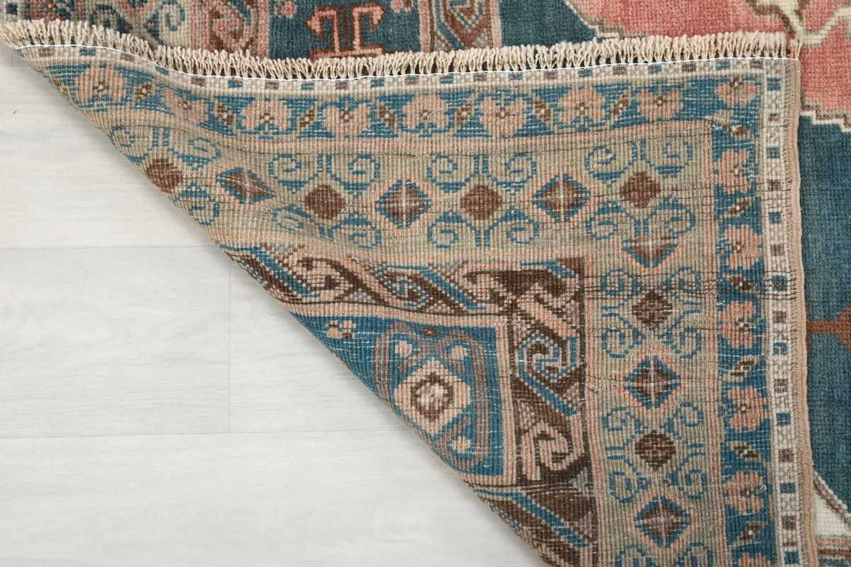 Detailed view of the rug's back, revealing the tightly woven cotton foundation and knots