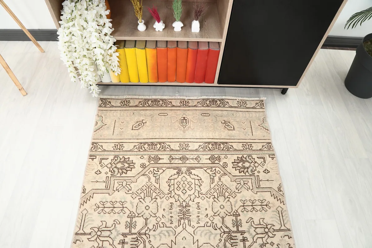 Close-up angled view of one end of the runner rug, showing the border and part of the main field pattern.
