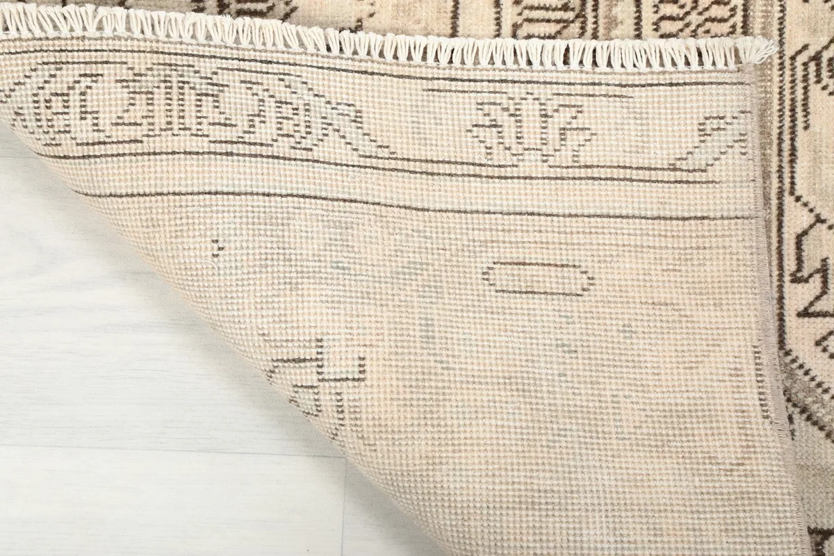 Close-up of the back of the hand-knotted rug, displaying the cotton foundation and knotting detail.