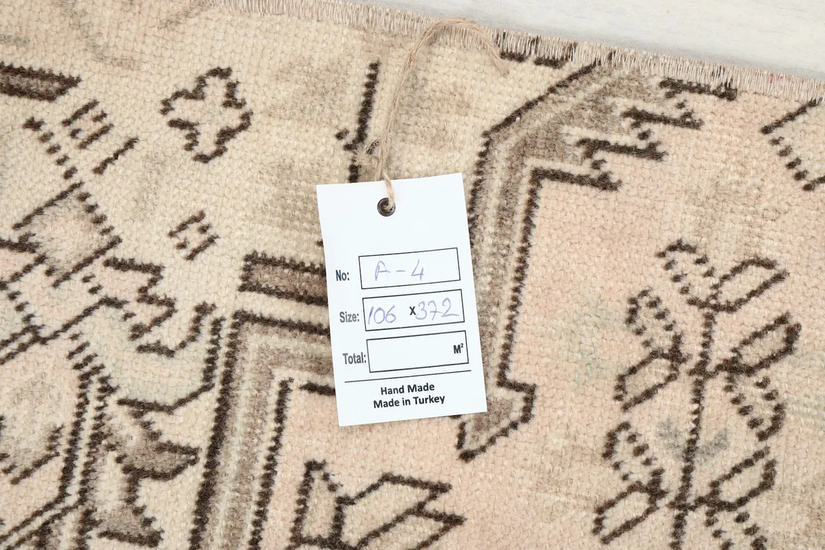 Image showing a product tag on the rug, indicating size and handmade origin in Turkey.