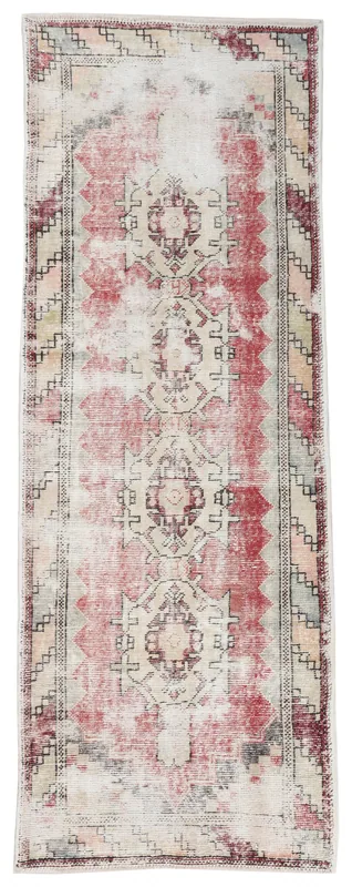 Full overhead view of the vintage rose and cream geometric Anatolian runner rug on a white background
