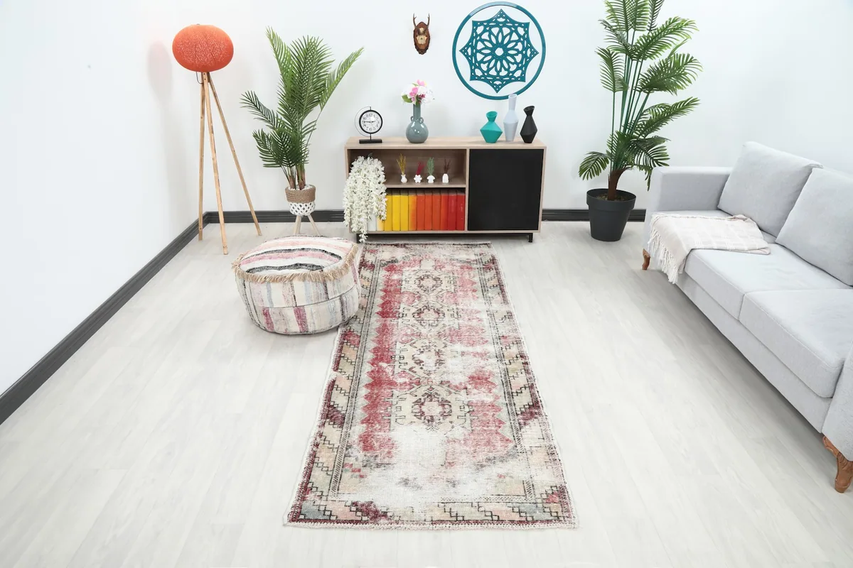 Vintage runner rug in a modern living space with a gray sofa and wooden cabinet