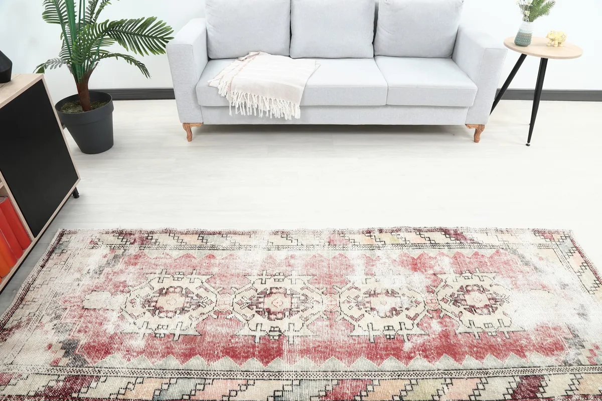 Overhead view of the middle section of the runner rug, showing the central geometric motifs and faded colors