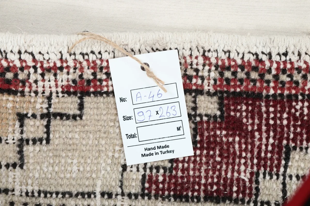 Close-up of the rug's tag, indicating its size and origin as hand-made in Turkey