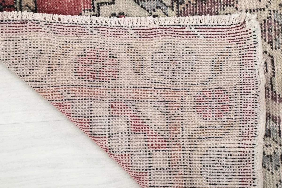 Underside of the rug, illustrating the cotton foundation and the tight, durable hand-knotting.