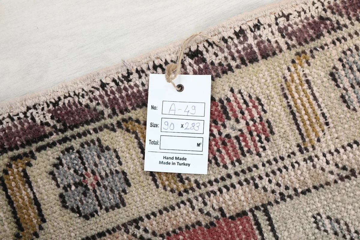 Close-up of the rug's tag with size information and 'Hand Made in Turkey' confirming its origin.