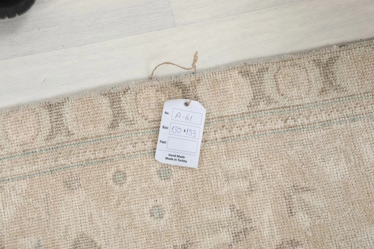 Rug corner with a label showing details, indicating its origin and materials