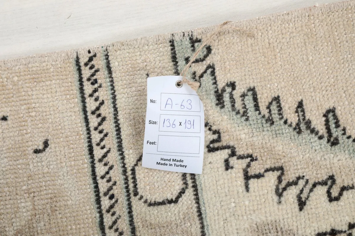 Close-up of the rug's back with a product tag showing dimensions and origin