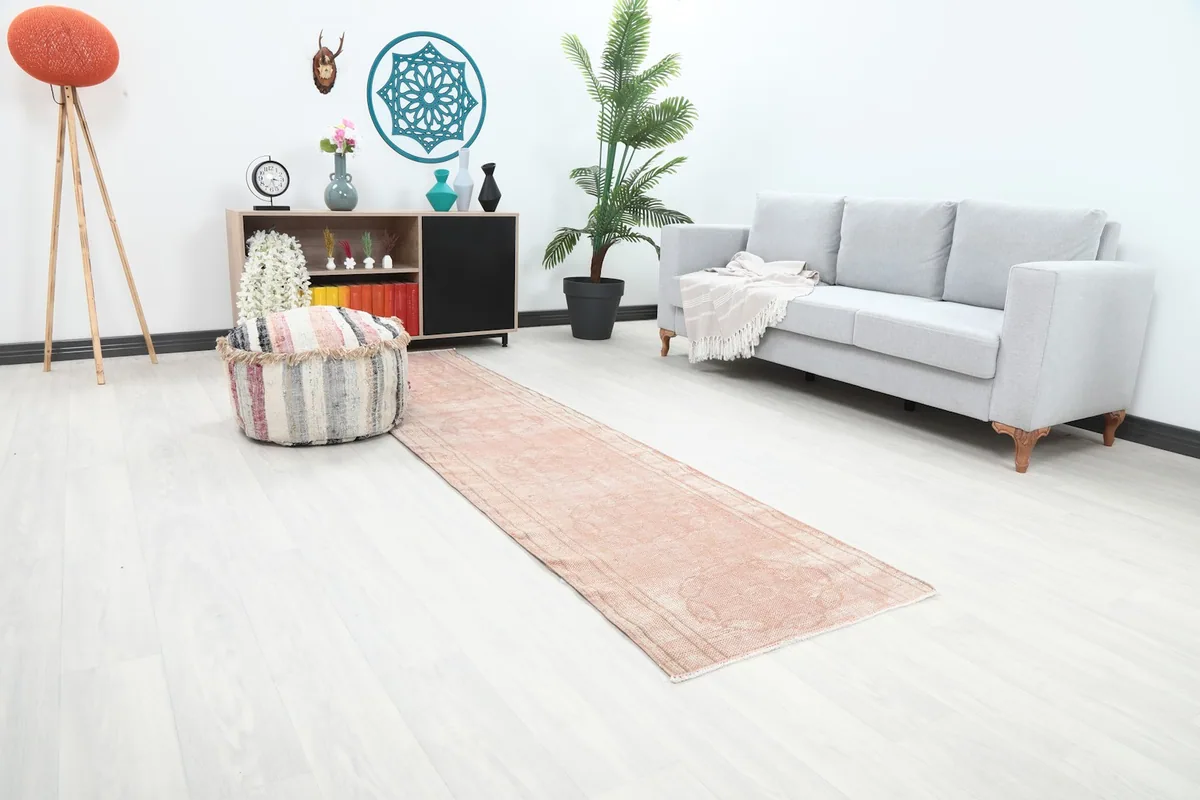 Overall view of the rose runner rug in a room, showing its length and placement