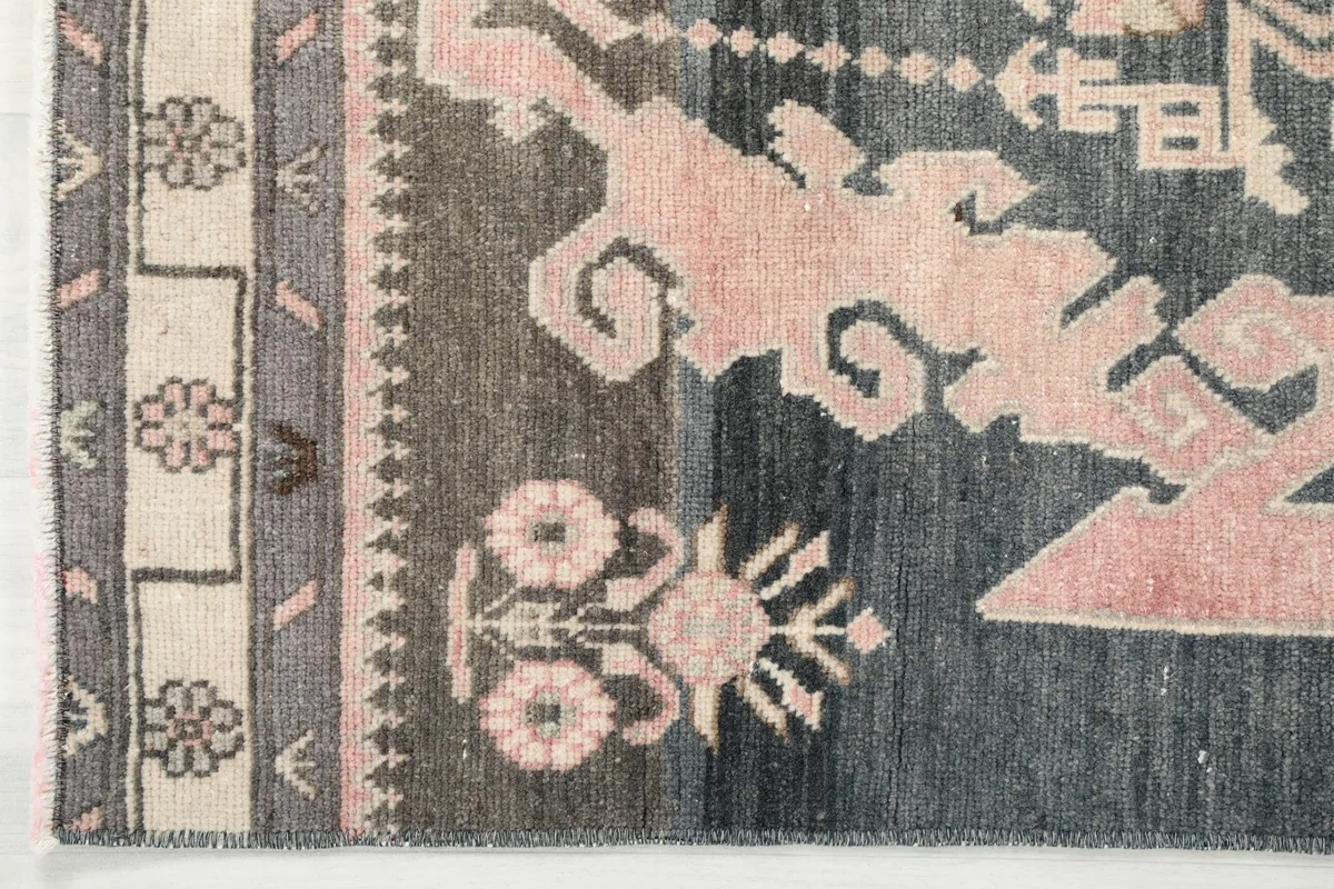 Close-up of the rug's border design, showing the ivory and brown elements next to the main field.