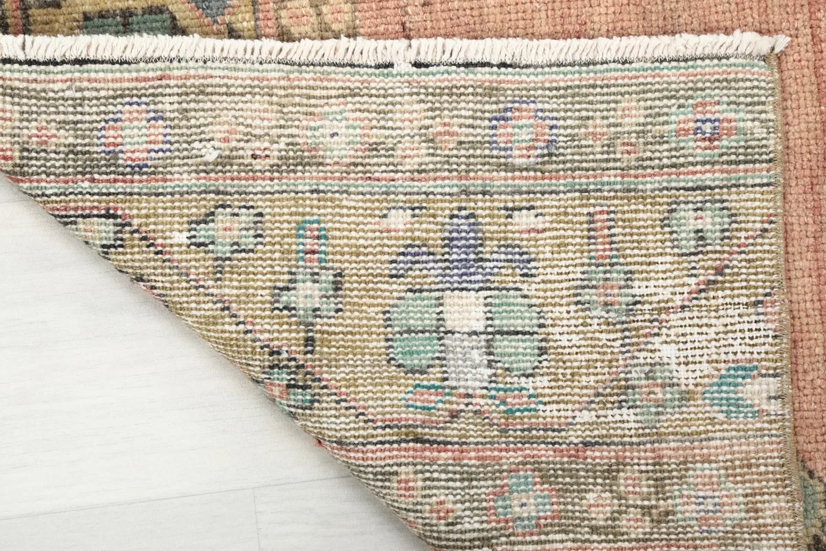 Close-up of the back of the hand-knotted runner, revealing the knotting and fringe