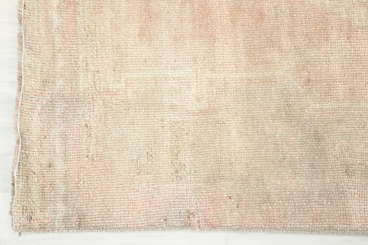 Edge detail of the hand-knotted vintage runner rug, showing the side finish and wool pile.