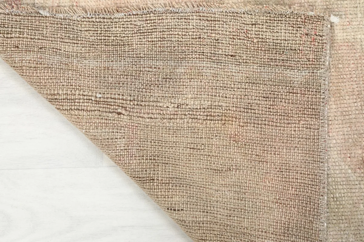Close-up of the cotton foundation from the back of the hand-knotted Anatolian runner rug.