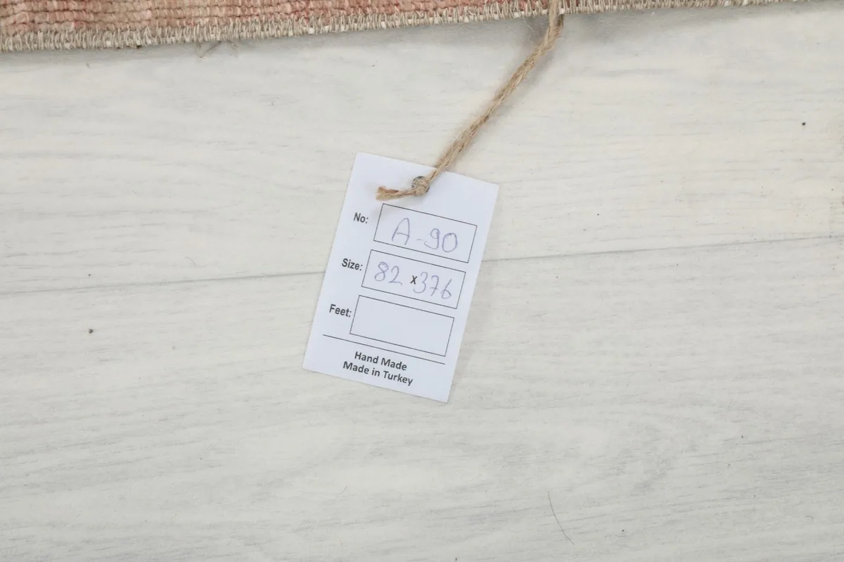Product tag showing the rug's dimensions in centimeters and confirming it is hand-made in Turkey.