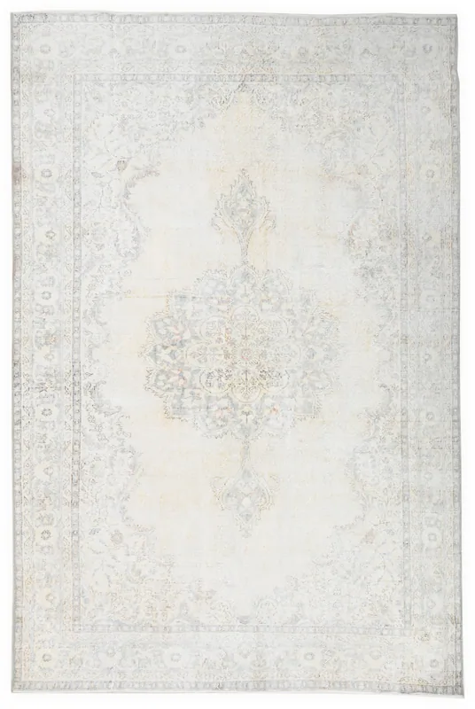 Full overhead view of the beige and cream vintage Anatolian area rug with a central medallion.