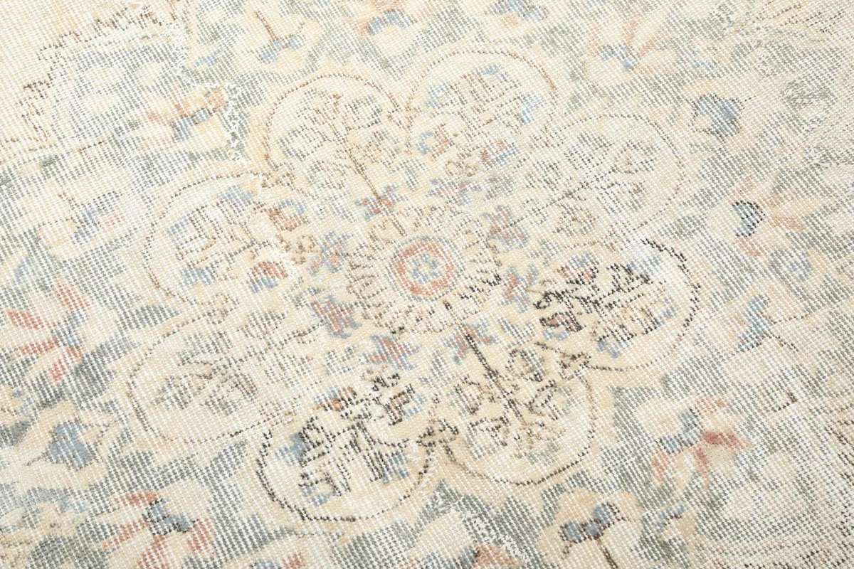 Detailed view of the intricate floral and geometric motifs within the rug's design.