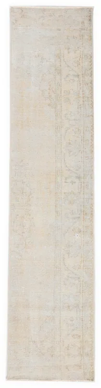Full overhead view of the 2'1" x 9'3" cream and beige vintage runner rug on a white background