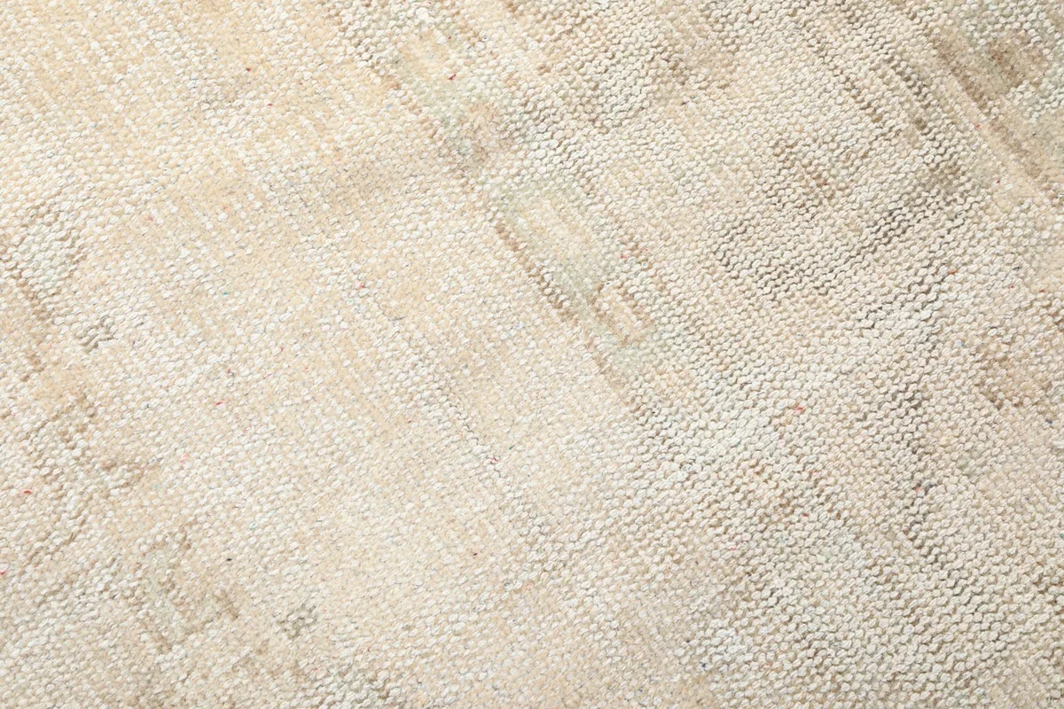 Close-up of the hand-knotted wool pile, highlighting the texture and low pile height