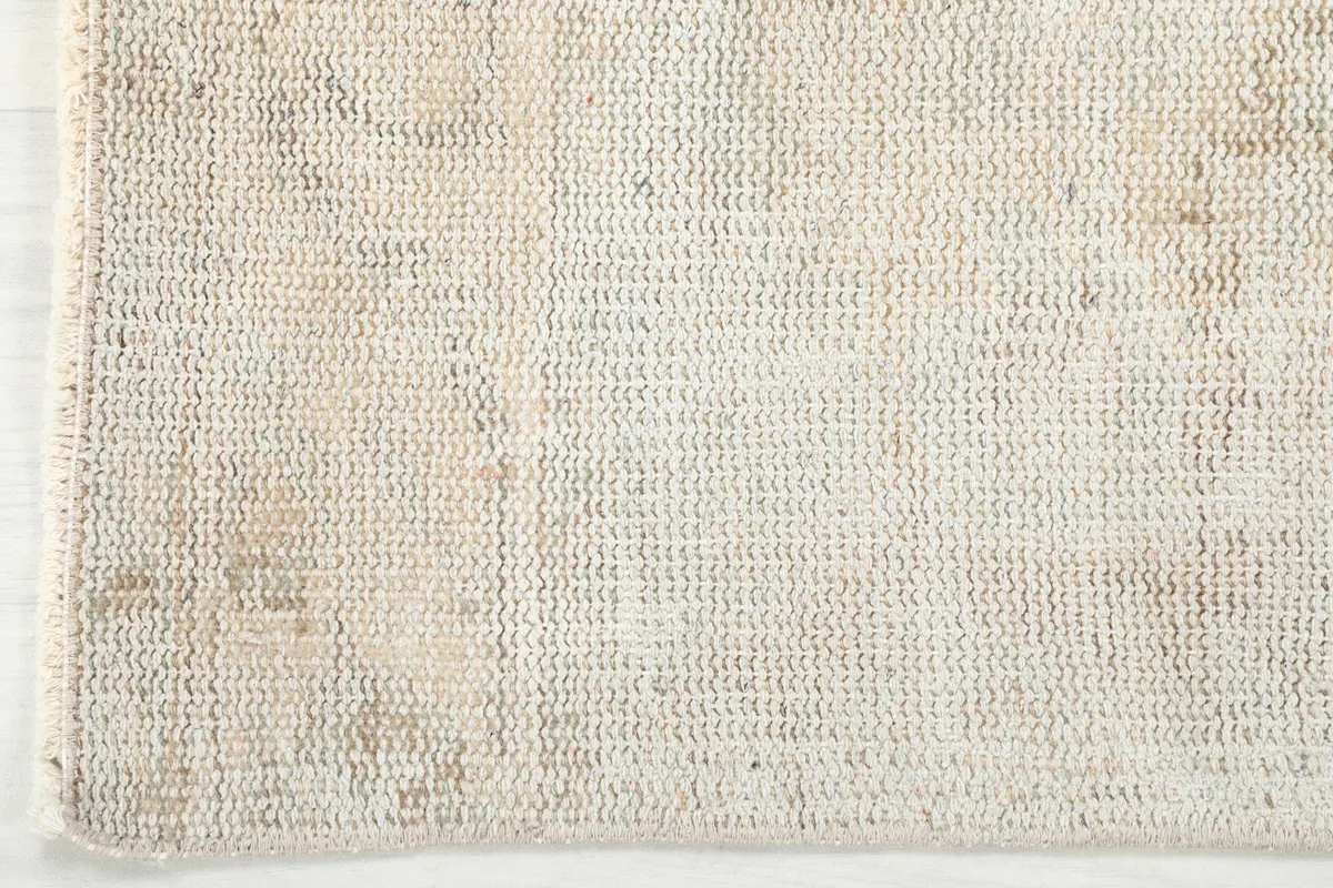 Underside view of the rug, revealing the cotton foundation and tight knotting