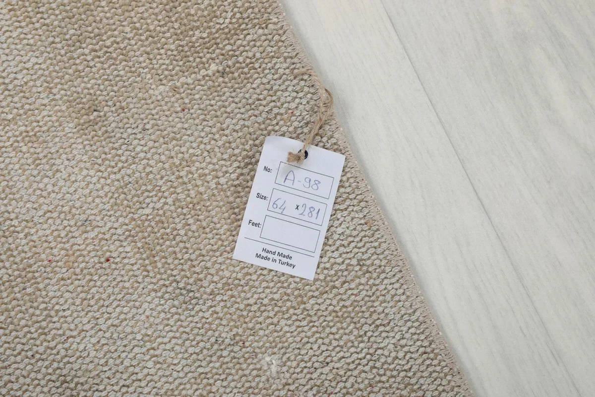 Close-up of the rug's label, indicating its handmade origin from Turkey