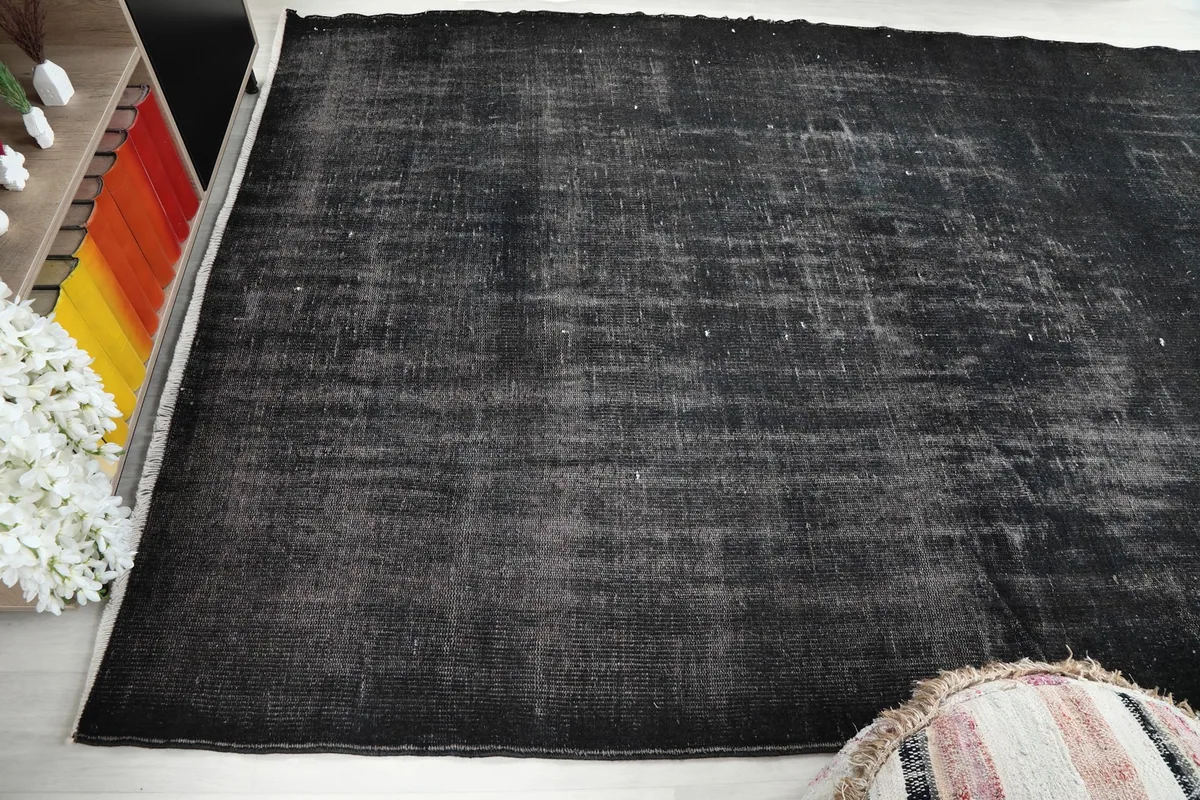 Another angle showing the full length of the rug, highlighting its rectangular shape and distressed look.