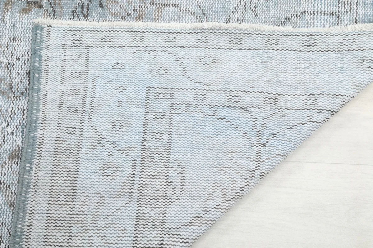Underside of the rug, showing the cotton foundation and knotting details