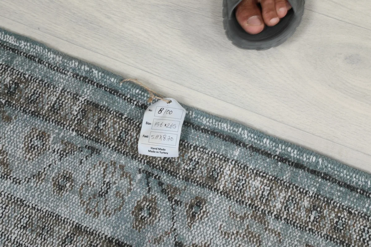 Close-up of the rug's label with size information and origin