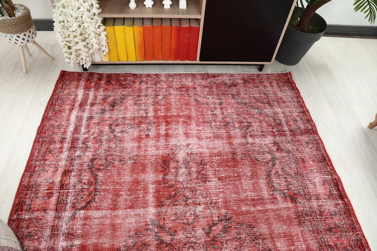 Overhead view of the red vintage rug in a room, showing its full length