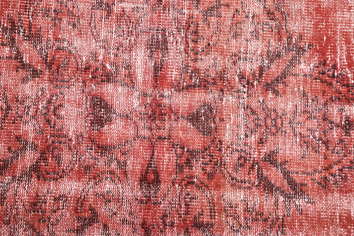 Close-up of the hand-knotted wool pile and faded charcoal patterns