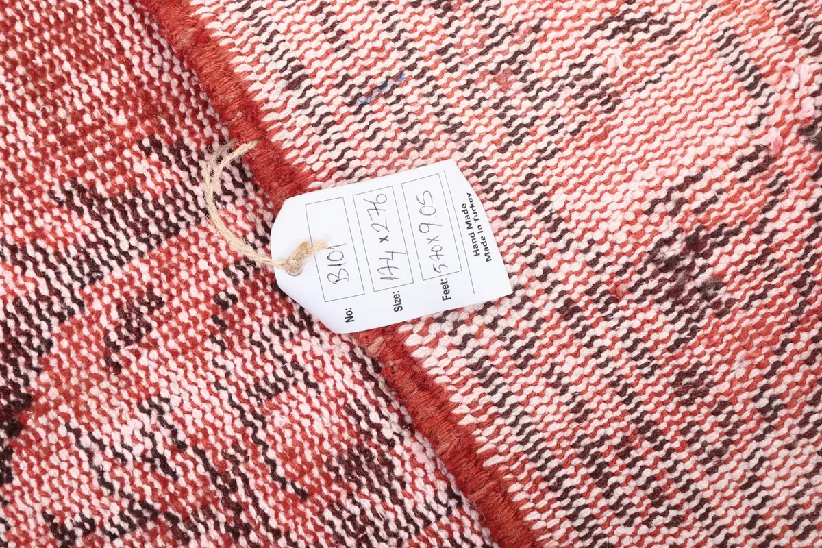 Detail of the rug's back with a tag showing size and origin information