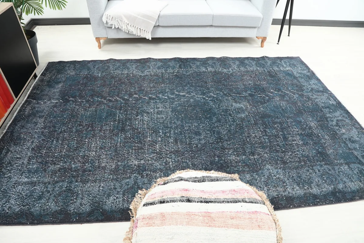 Wide shot of the rug centered in the room, offering a broad perspective of its size and effect.