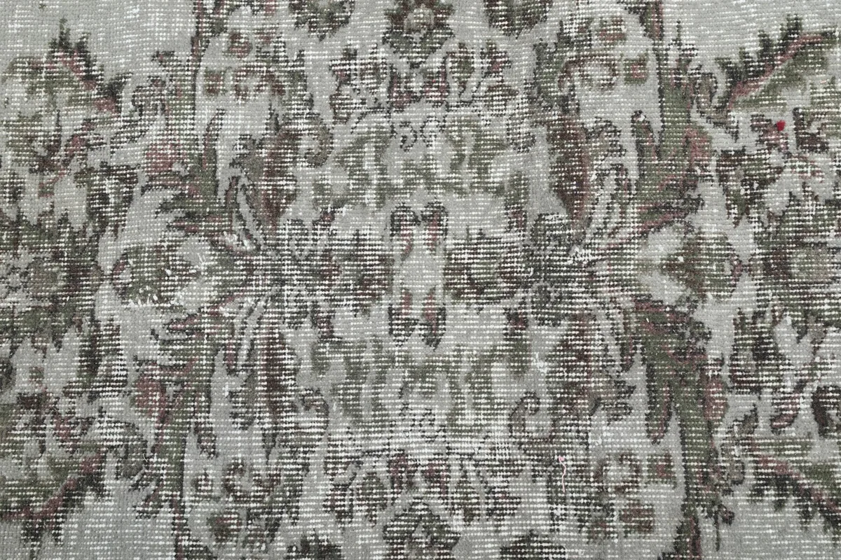Close-up of the rug's surface, revealing the intricate hand-knotted wool pile and subtle color shifts