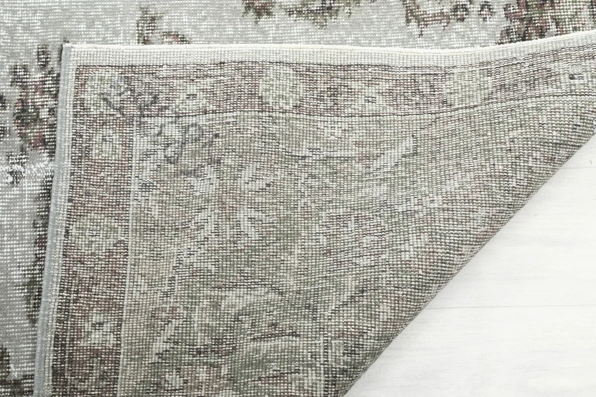 Close-up of the rug's underside, revealing the tightly woven cotton foundation and knotting details