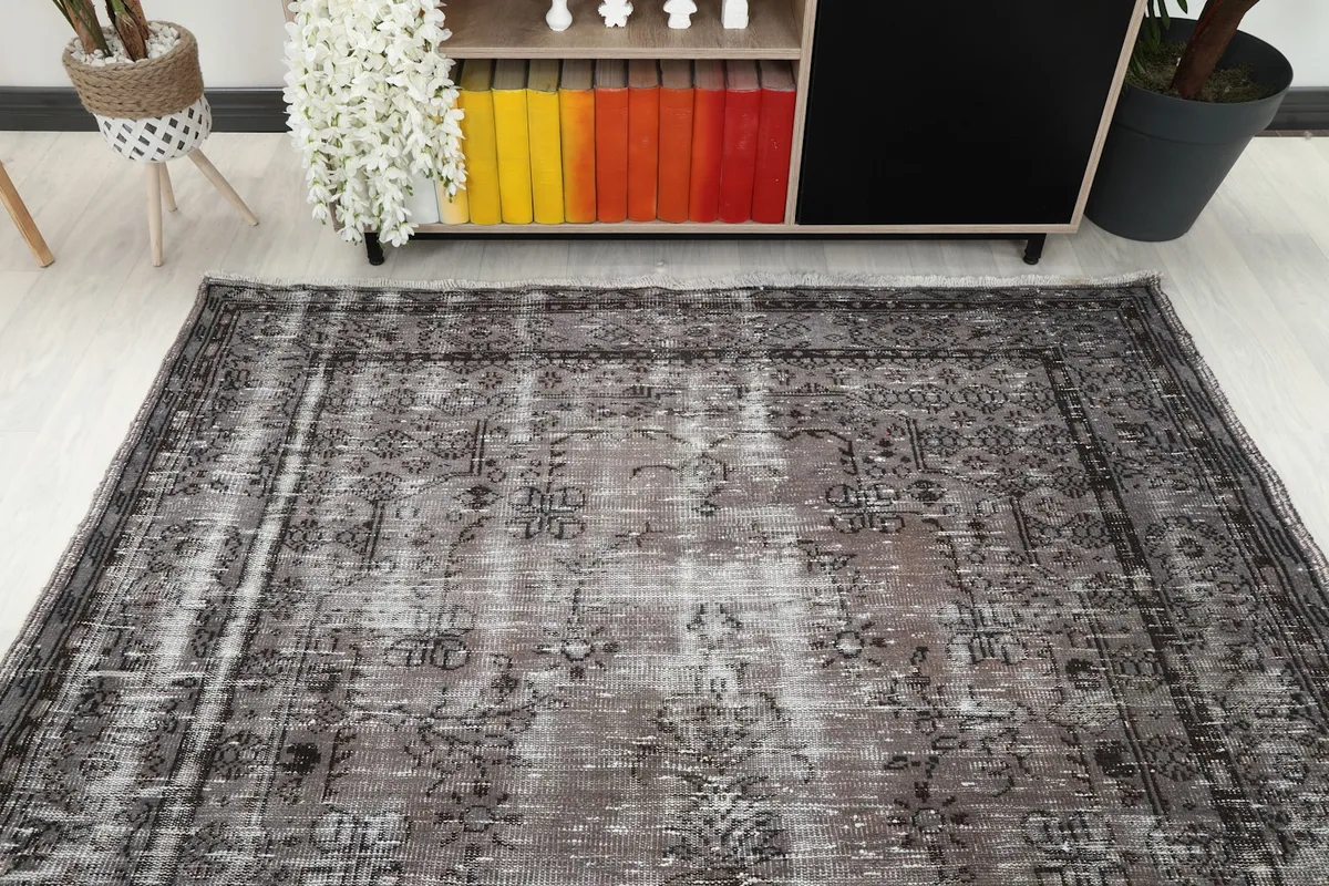 Overhead view of the gray and charcoal rug in a room, showing its full length