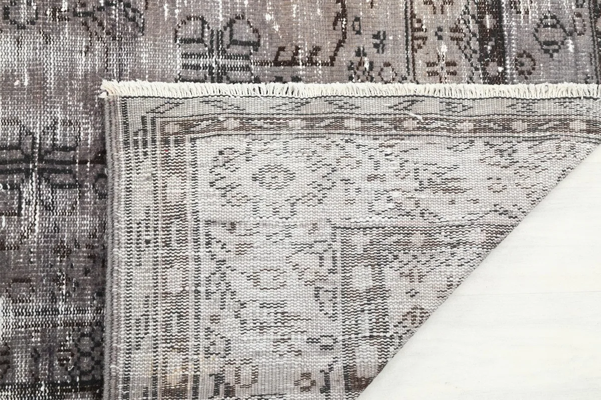 Detail of the rug's backside and a corner of the pile, showing craftsmanship